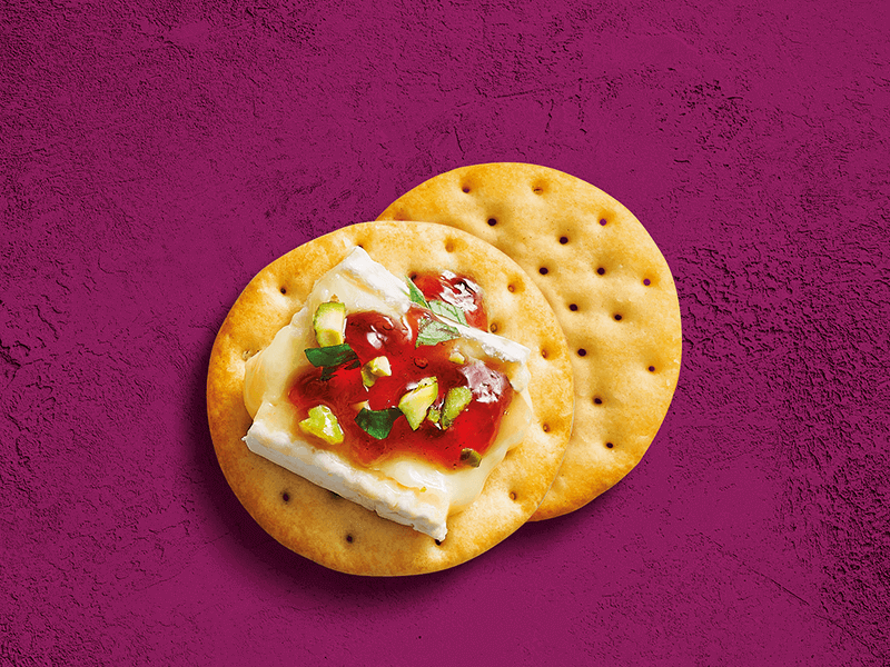 Toasteds® Crackers topped with Brie, Cranberry Jam & Pistachio